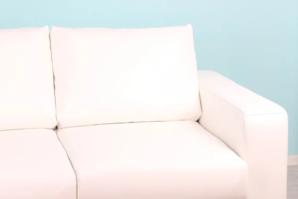 Sofá blanco primer plano en la habitación sobre fondo azul — Foto de Stock