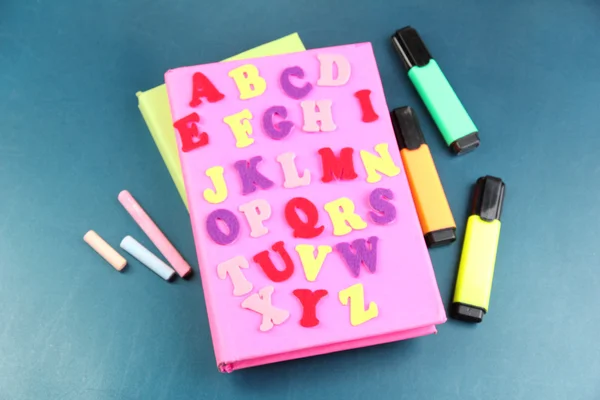 English alphabet, books and markers on school desk — Stock Photo, Image