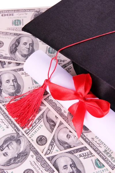 Graduation hat and scroll on money background — Stock Photo, Image