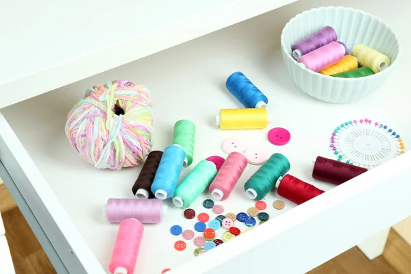 Sewing accessories in open drawer close up — Stock Photo, Image