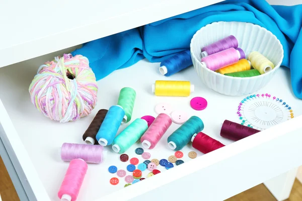 Sewing accessories in open drawer close up — Stock Photo, Image