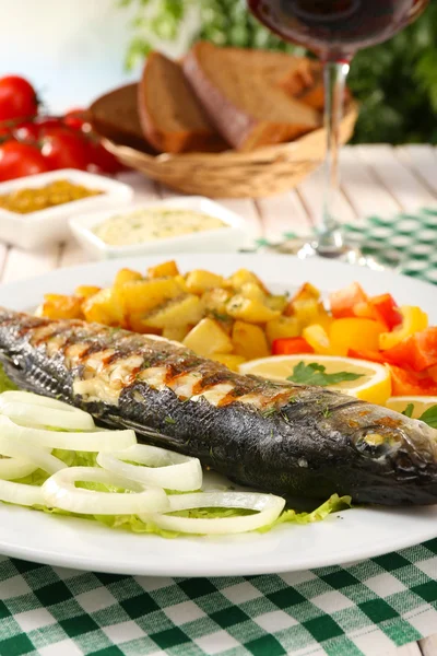 Delicioso pescado a la parrilla en el plato en primer plano de la mesa —  Fotos de Stock