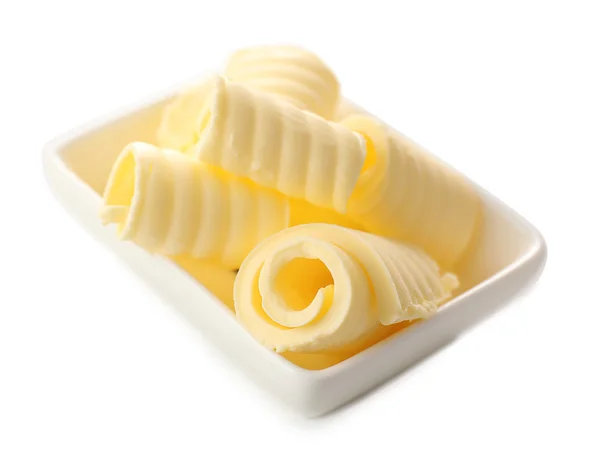 Curls of fresh butter in bowl, isolated on white — Stock Photo, Image