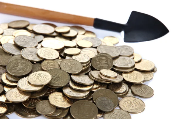 Coins with shovel close up — Stock Photo, Image