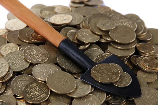 Coins with shovel close up — Stock Photo, Image
