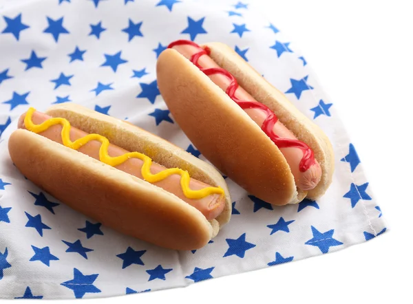 Tasty hot dogs on napkin with stars, isolated on white — Stock Photo, Image