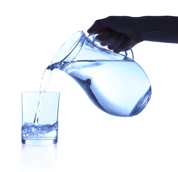 Pouring water into glass on blue background — Stock Photo, Image