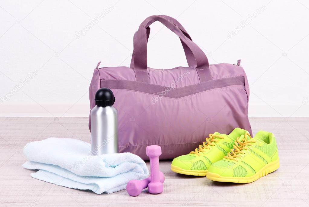 Sports bag with sports equipment in gymnasium