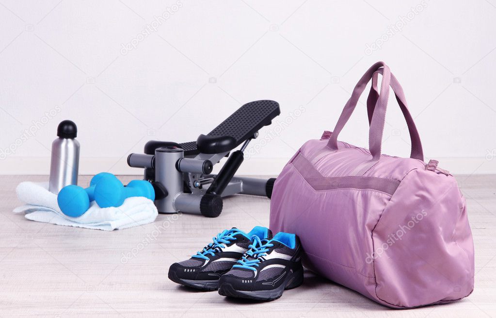 Sports bag with sports equipment in gymnasium