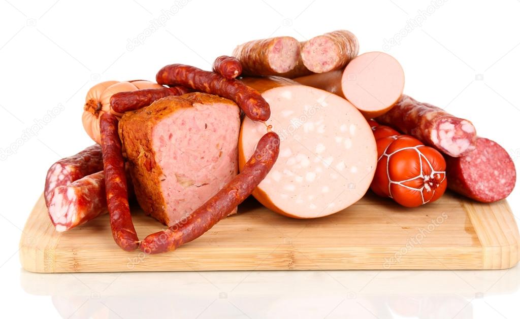 Lot of different sausages on wooden board isolated on white