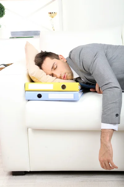 Elegant young businessman sleeping on sofa, at home — Stock Photo, Image