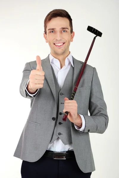 Empresario posando con palo de golf aislado en blanco — Foto de Stock