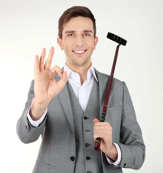 Empresario posando con palo de golf aislado en blanco —  Fotos de Stock