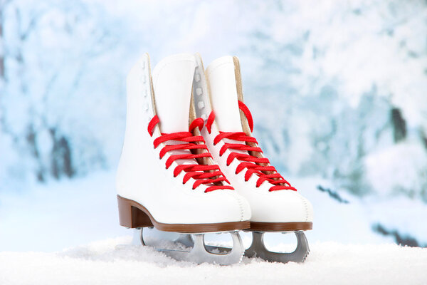 Figure skates on winter background