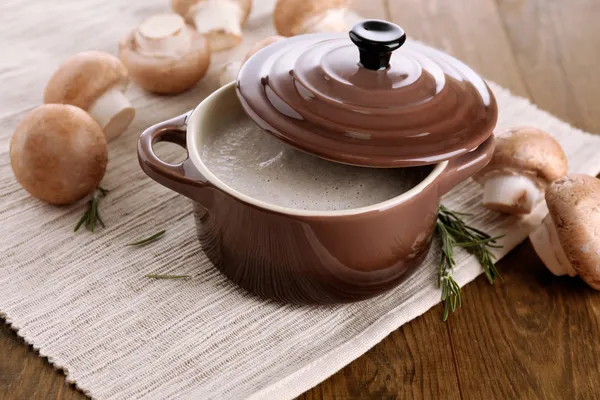 Mushroom soup in pot, on wooden background — Stock Photo, Image