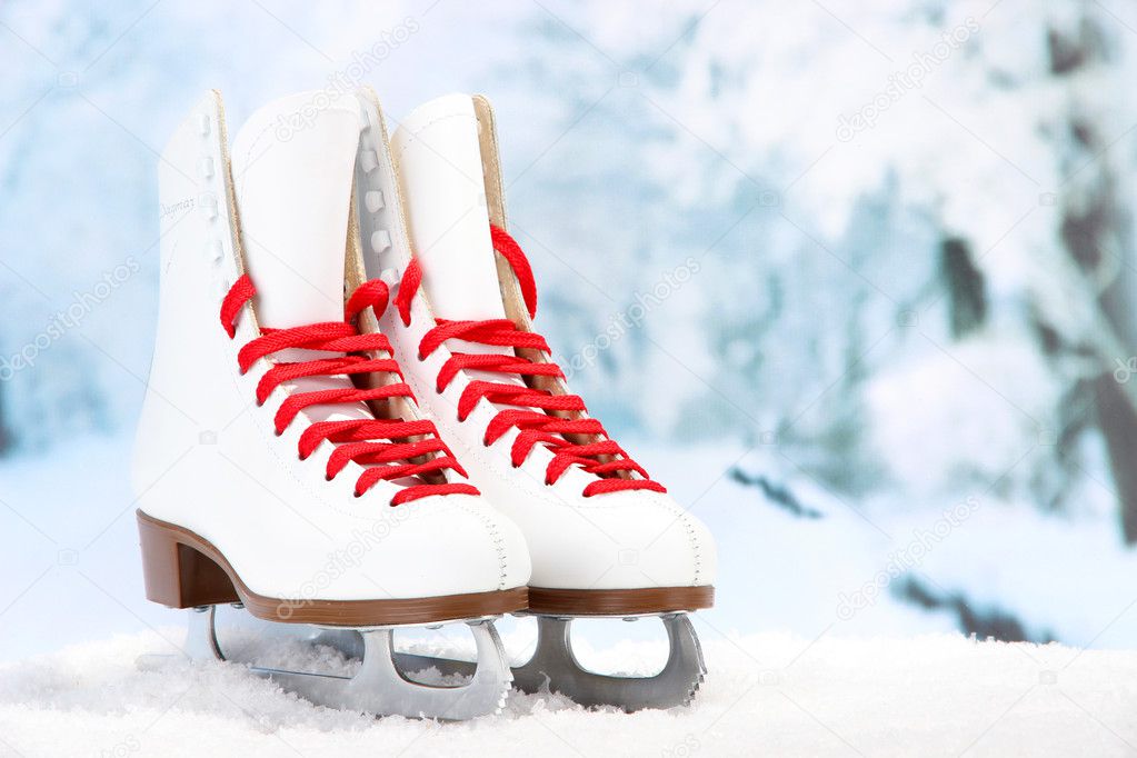 Figure skates on winter background