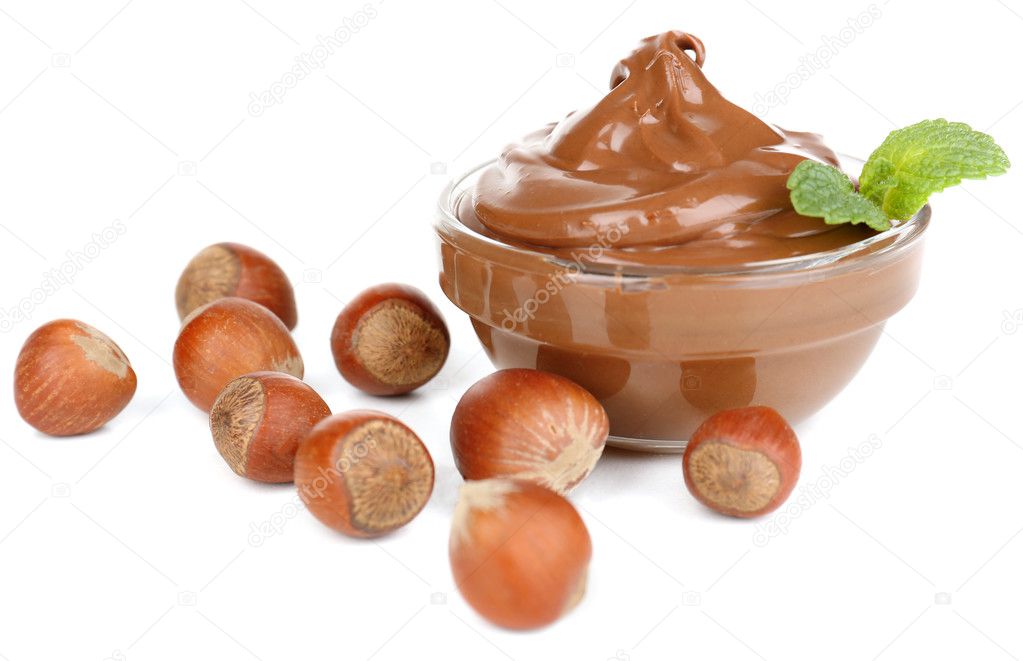 Sweet chocolate hazelnut spread with whole nuts and mint isolated on white