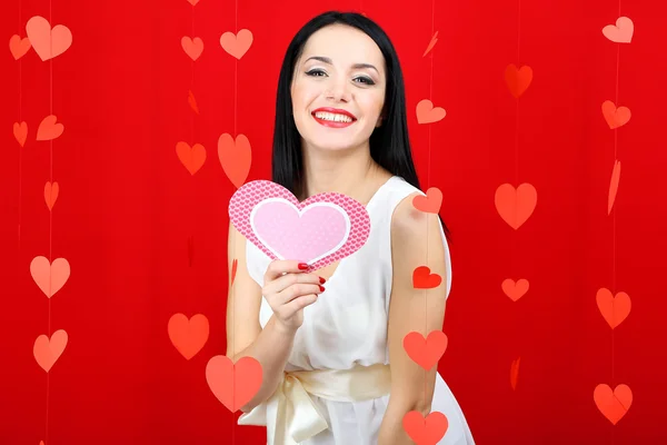 Attractive young woman with card on Valentine Day — Stock Photo, Image