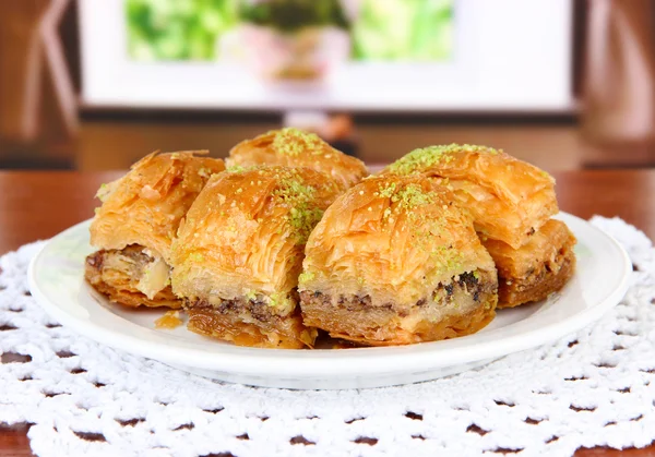 Sweet baklava on plate on table in room — Stock Photo, Image