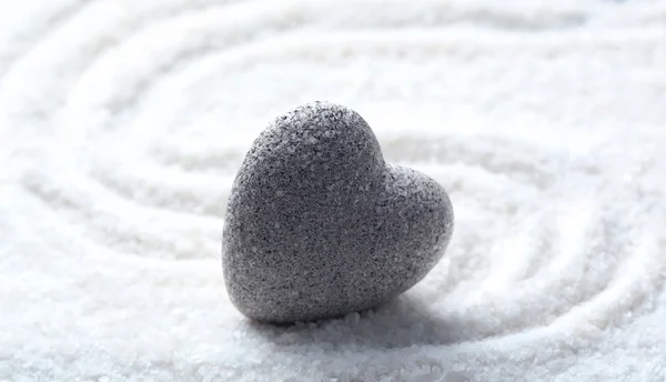 Grey zen stone in shape of heart, on sand background — Stock Photo, Image