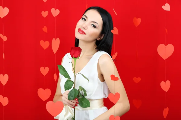 Attractive young woman with rose on Valentine Day — Stock Photo, Image