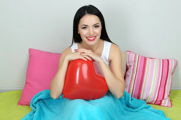 Beautiful woman with balloon in bed on Valentine Day — Stock Photo, Image