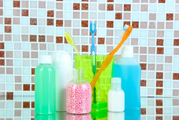 Cosmetics and bath accessories on mosaic tiles background — Stock Photo, Image