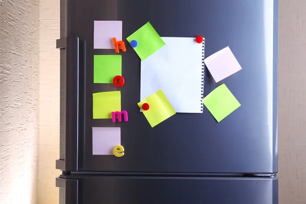 Empty paper sheets and colorful magnets on fridge door — Stock Photo, Image