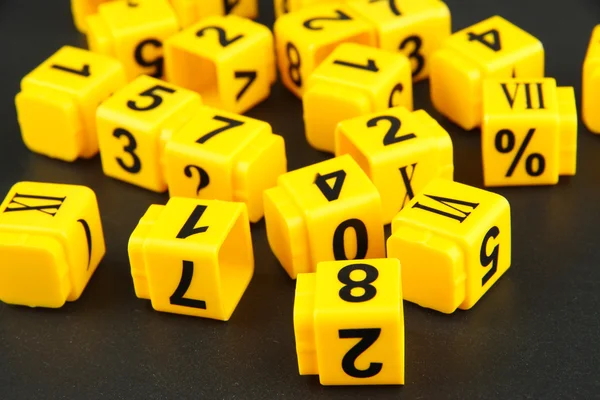Educational cubes with different numbers on black board — ストック写真