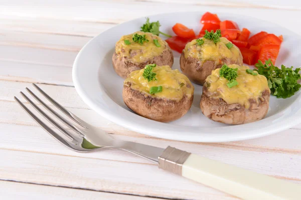 Stuffed mushrooms on plate on table on light background — Stock Photo, Image