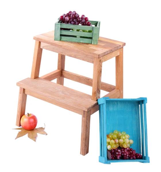 Scatola di legno con frutta, su piccola scala di legno, isolata su bianco — Foto Stock