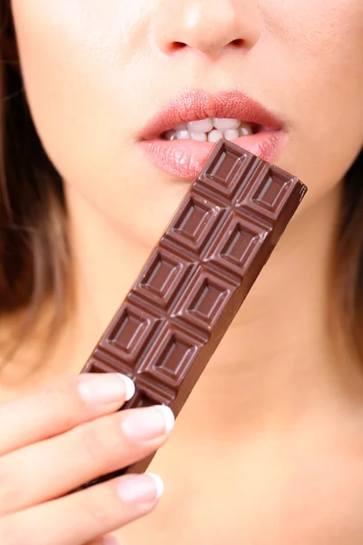 Closeup of woman eating chocolate Royalty Free Stock Images