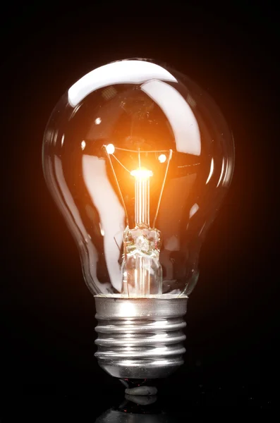 Light bulb on dark background — Stock Photo, Image