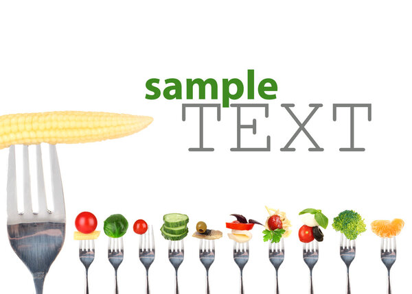 Different food on forks isolated on white