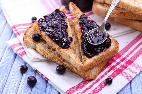 Delicious toast with jam on table close-up — Stock Photo, Image