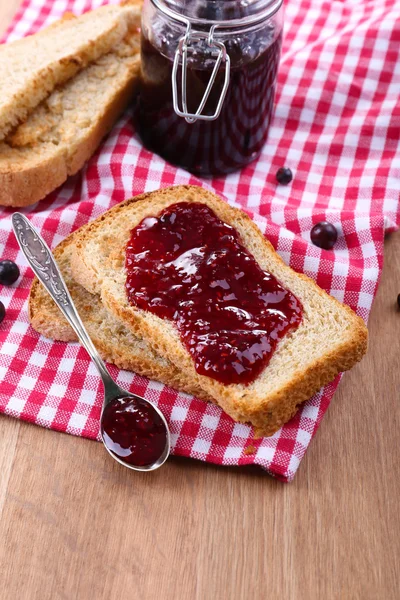 Delicious toast with jam on table close-up — Stock Photo, Image