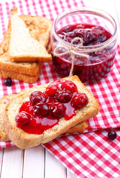 Delicious toast with jam on table close-up — Stock Photo, Image