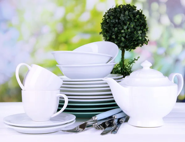 Clean dishes on table on natural background — Stock Photo, Image