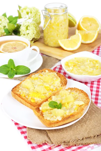 Delicious toasts with lemon jam on plate on table close-up — Stock Photo, Image