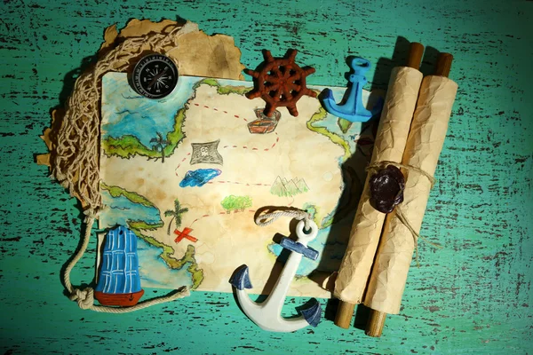 Treasure map with sea accessories, on wooden background — Stock Photo, Image