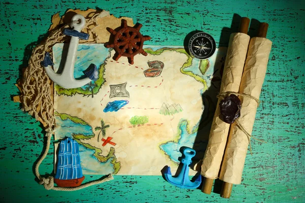 Treasure map with sea accessories, on wooden background — Stock Photo, Image