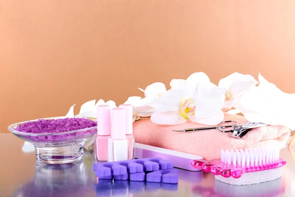 Pedicure set on table on beige background — Stock Photo, Image