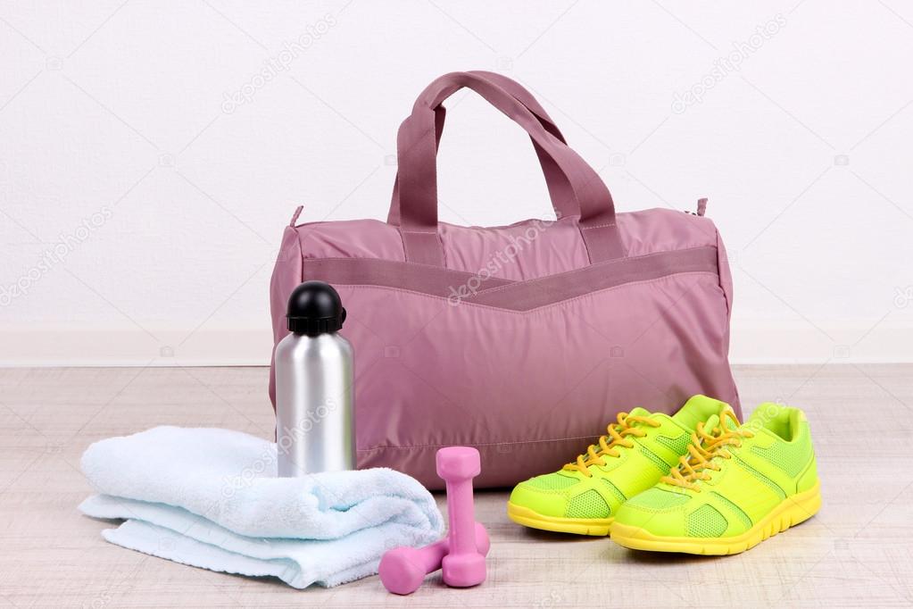 Sports bag with sports equipment in gymnasium