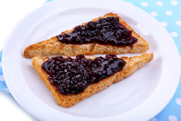 Delicious toast with jam on plate close-up — Stock Photo, Image