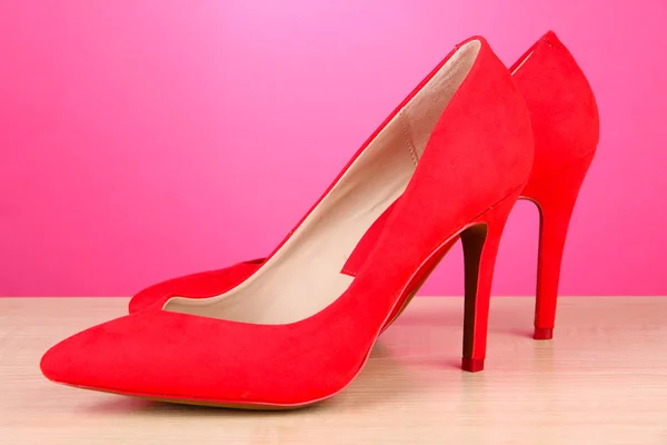 Beautiful red female shoes, on pink background — Stock Photo, Image