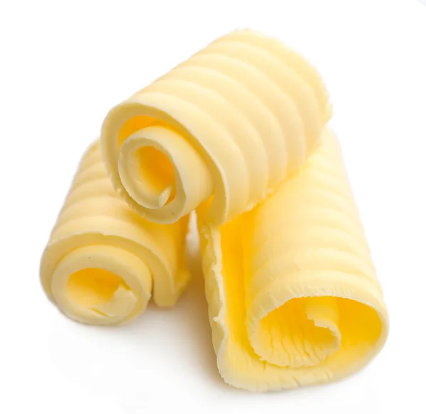 Curls of fresh butter, isolated on white — Stock Photo, Image