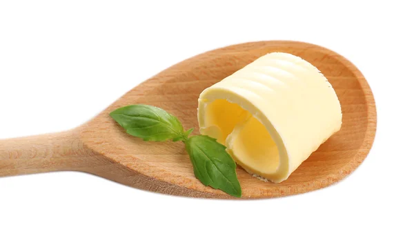 Curl of fresh butter with basil on wooden spoon, isolated on white — Stock Photo, Image