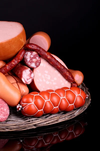 Lot of different sausages on black background — Stock Photo, Image