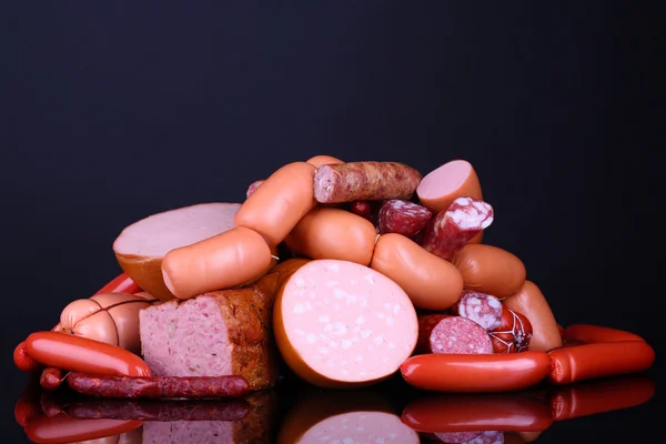 Lot of different sausages on black background — Stock Photo, Image
