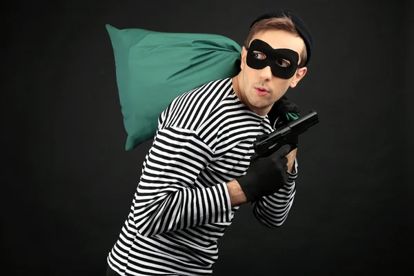 Thief with bag isolated on black — Stock Photo, Image